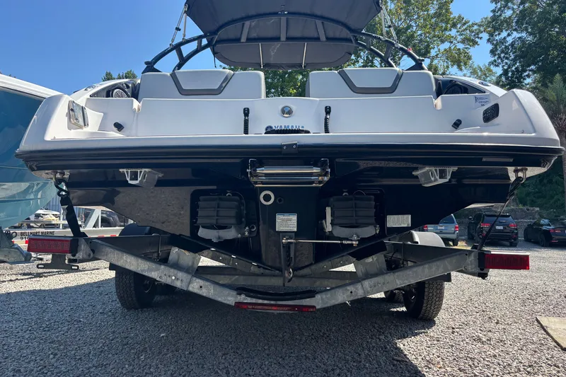 Slide: The Image of 2023 Yamaha Boats AR250 on trailer, rear view, parked outdoors. - 4