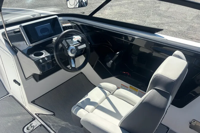 Slide: The Image of 2023 Yamaha Boats AR250 cockpit with steering wheel and digital display. - 10