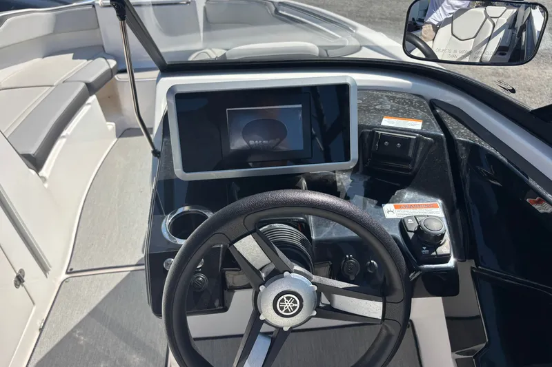 Slide: The Image of 2023 Yamaha Boats AR250 dashboard with steering wheel and touchscreen display. - 11