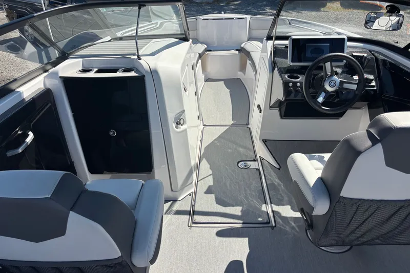 Slide: The Image of 2023 Yamaha Boats AR250 interior with modern dashboard and seating. - 15