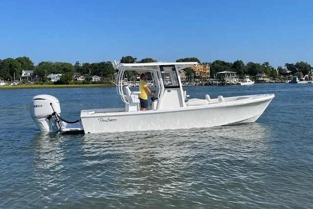 The Image of 2026 Pair Customs 24 Center Console MV boat on calm water, side view. - 1
