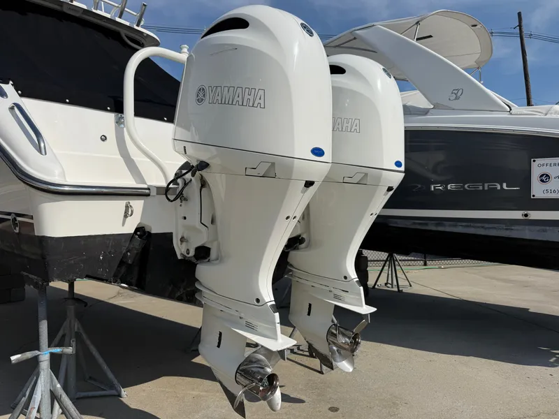 Slide: The Image of Two Yamaha outboard engines are mounted on the stern of a Pursuit DC 265 Dual Console boat. - 1