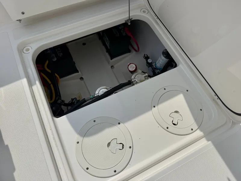 Slide: The Image of An open compartment on a boat reveals batteries and wiring. - 29