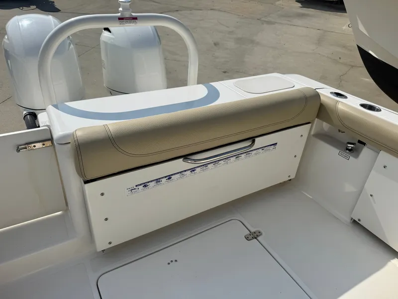 Slide: The Image of The image shows the cockpit of a 2019 Pursuit DC 265 Dual Console boat with beige upholstery. - 5