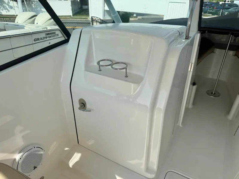 Slide: The Image of The image shows the cockpit of a 2019 Pursuit DC 265 Dual Console with a cup holder. - 16