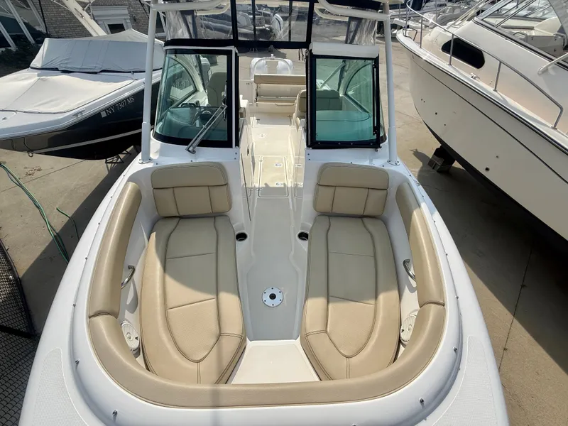 Slide: The Image of The 2019 Pursuit DC 265 Dual Console features a spacious, cushioned seating arrangement in the bow area. - 23