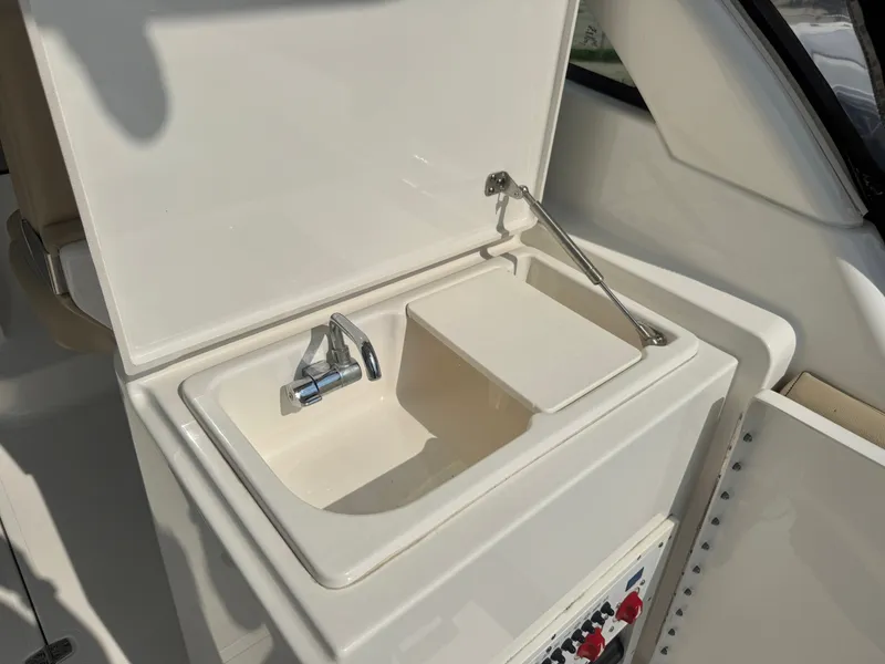 Slide: The Image of A sink with a faucet and cover on a boat. - 14