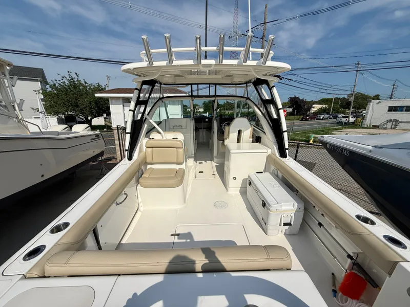 Slide: The Image of 2019 Pursuit DC 265 Dual Console with spacious cockpit and beige upholstery, perfect for outings. - 4