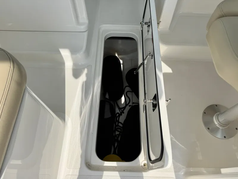 Slide: The Image of An open storage compartment on a boat with visible accessories inside. - 25