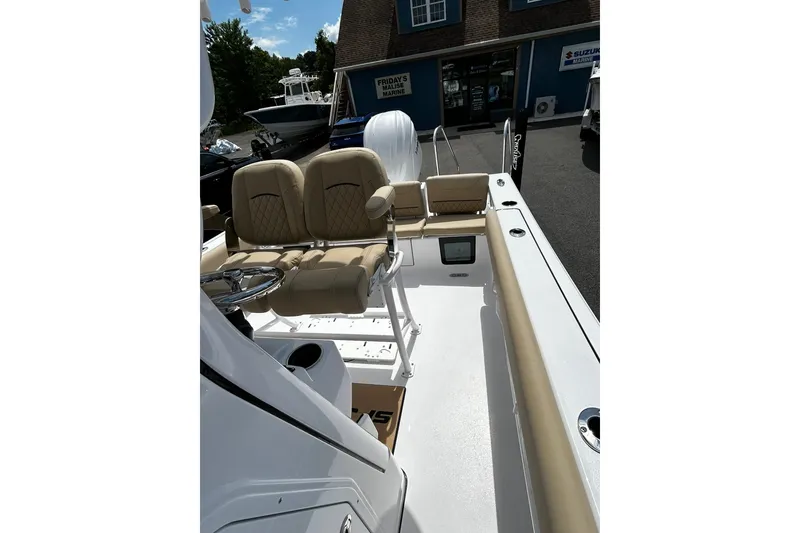 Slide: The Image of 2026 Sportsman Heritage 231 Center Console boat with beige seating and sleek design. - 5