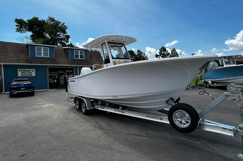 The Image of 2026 Sportsman Heritage 231 Center Console boat on trailer at marine dealership. - 1