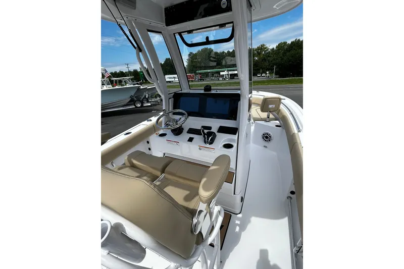 Slide: The Image of 2026 Sportsman Heritage 231 Center Console boat interior with modern helm and seating. - 6