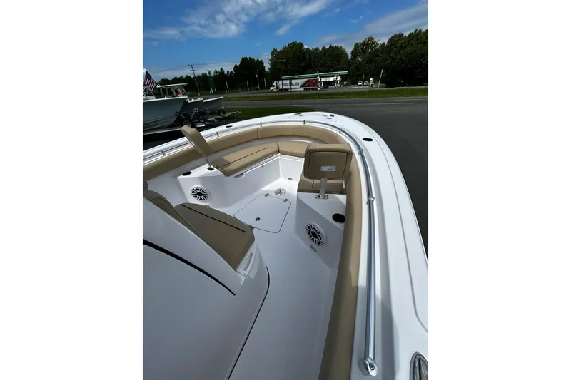 Slide: The Image of 2026 Sportsman Heritage 231 Center Console boat interior with cushioned seating and speakers. - 2