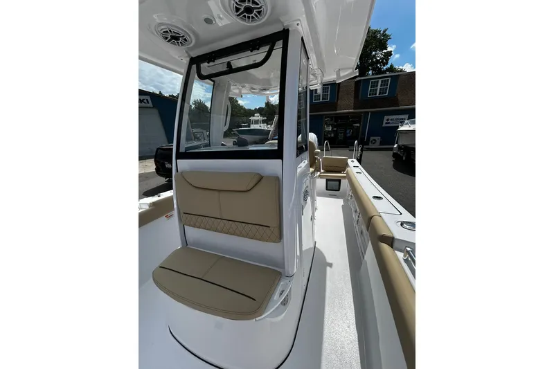 Slide: The Image of 2026 Sportsman Heritage 231 Center Console boat interior with tan seating and modern design. - 4