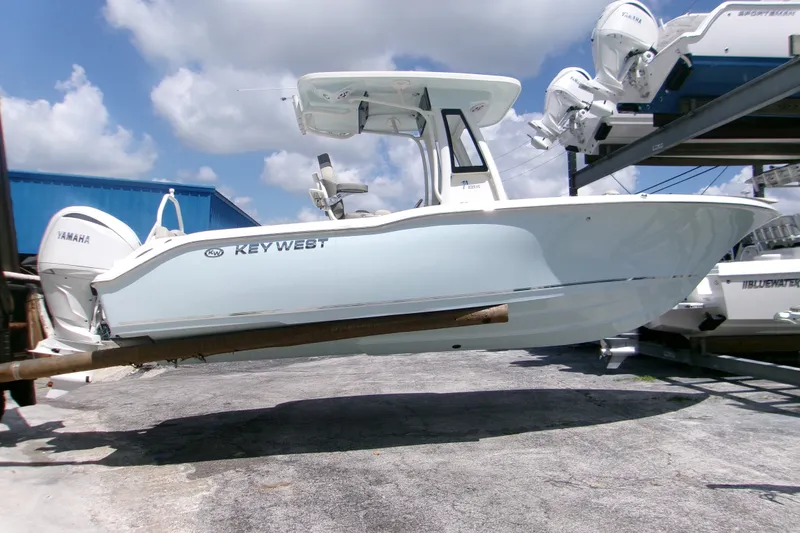 Slide: The Image of 2026 Key West 239 FS boat on display, featuring Yamaha engine, under a clear blue sky. - 19