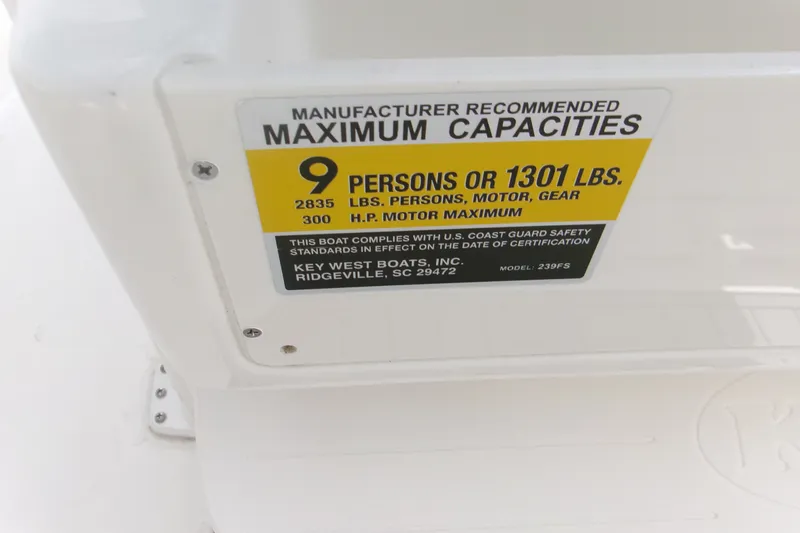 Slide: The Image of Key West 239 FS 2026 boat capacity label, 9 persons or 1301 lbs maximum. - 14