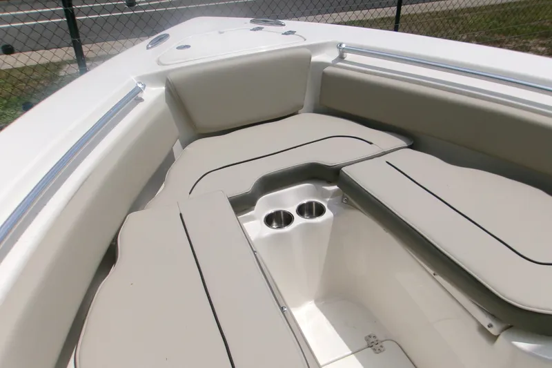 Slide: The Image of 2026 Key West 239 FS boat interior with cushioned seating and cup holders. - 10