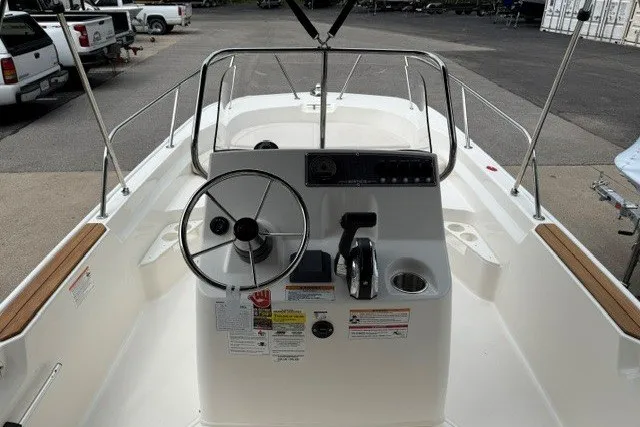 Slide: The Image of 2027 Boston Whaler 170 Montauk boat interior with steering wheel and control panel. - 4