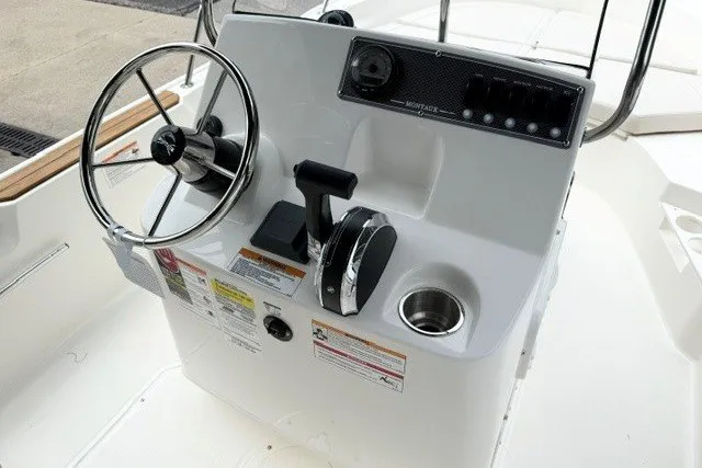 Slide: The Image of 2027 Boston Whaler 170 Montauk boat console with steering wheel and controls. - 3