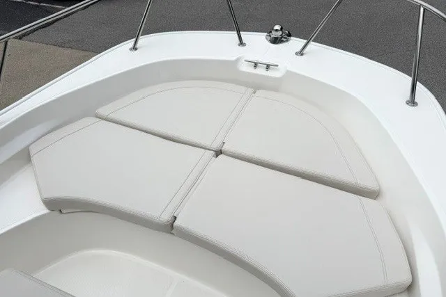 Slide: The Image of 2027 Boston Whaler 170 Montauk boat bow with cushioned seating and stainless steel railings. - 6