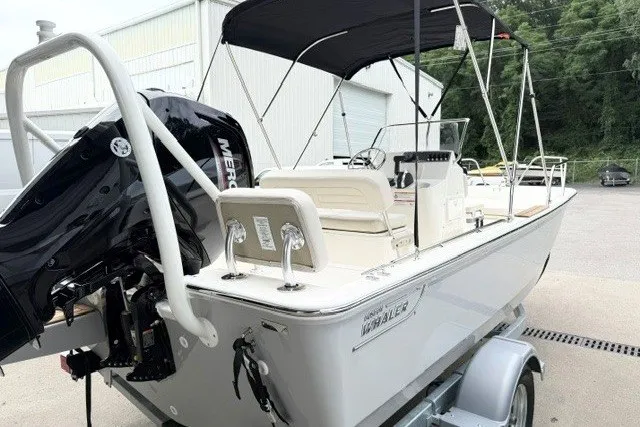Slide: The Image of 2027 Boston Whaler 170 Montauk boat on trailer, featuring a Mercury outboard motor. - 13