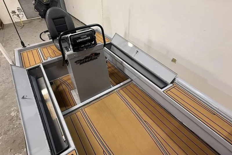 Slide: The Image of 2023 Gator Tail 1860 Extreme boat interior with Lowrance equipment and wood-patterned flooring. - 10