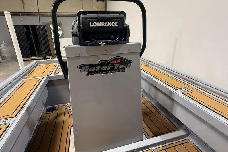 Slide: The Image of 2023 Gator Tail 1860 Extreme boat interior with Lowrance equipment and wood-patterned flooring. - 8