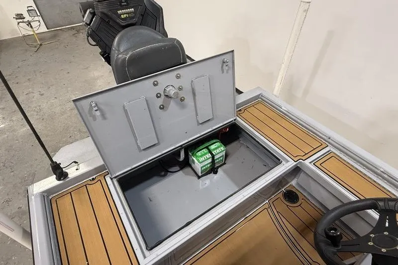 Slide: The Image of 2023 Gator Tail 1860 Extreme boat interior with open storage compartment and battery. - 4