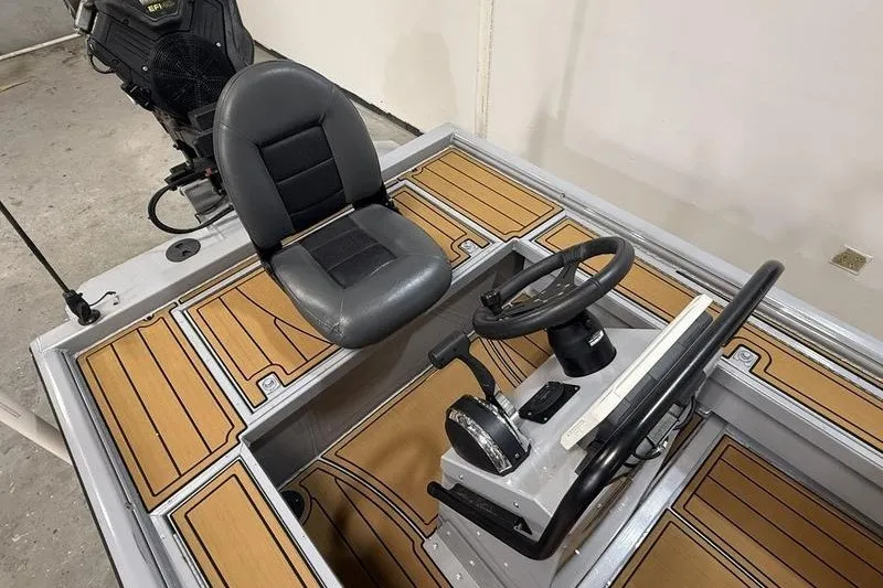 Slide: The Image of 2023 Gator Tail 1860 Extreme boat interior with steering console and cushioned seat. - 6