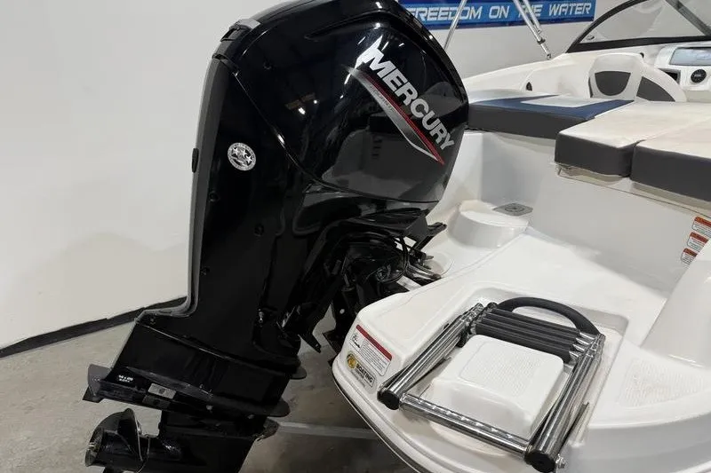 Slide: The Image of 2021 Tahoe 450 TS boat with Mercury outboard motor and swim platform ladder. - 4