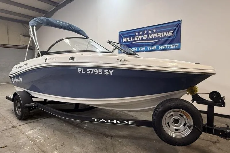 Slide: The Image of 2021 Tahoe 450 TS boat on trailer at Miller's Marine showroom. - 1