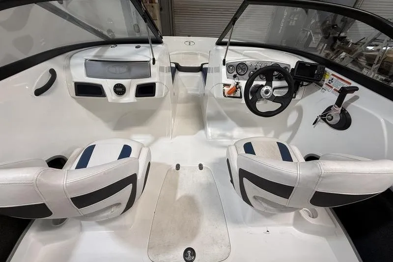 Slide: The Image of 2021 Tahoe 450 TS boat interior with dual seats and steering console. - 11