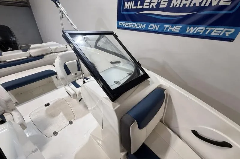 Slide: The Image of 2021 Tahoe 450 TS boat interior with blue and white seating, displayed at Miller's Marine. - 12