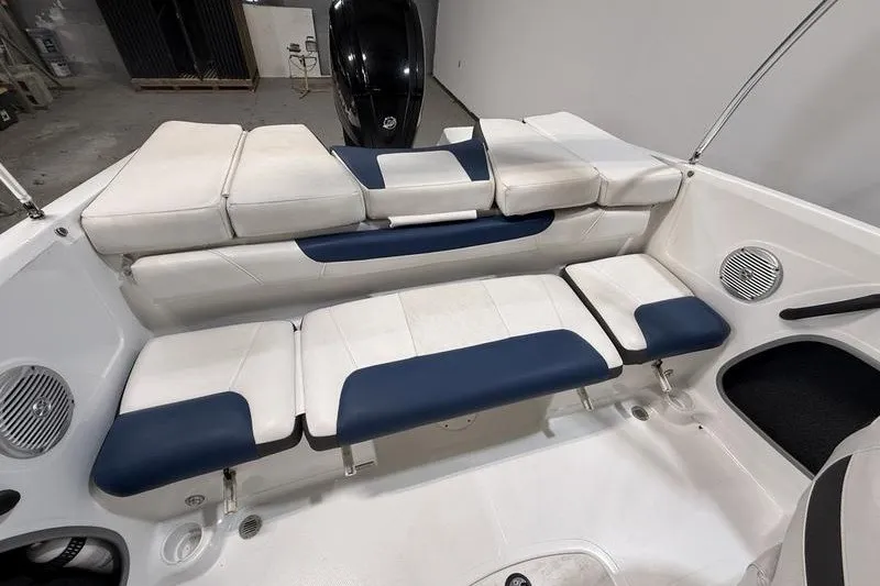 Slide: The Image of 2021 Tahoe 450 TS boat interior with white and blue cushioned seating. - 9