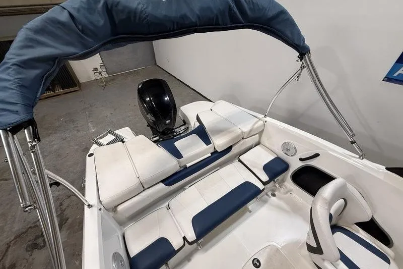 Slide: The Image of 2021 Tahoe 450 TS boat interior with blue and white seating and canopy. - 5