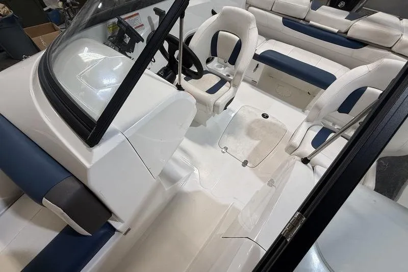 Slide: The Image of 2021 Tahoe 450 TS boat interior with white and blue seating arrangement. - 13