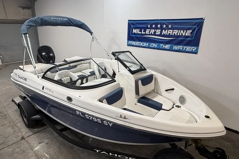 Slide: The Image of 2021 Tahoe 450 TS boat displayed at Miller's Marine showroom. - 2