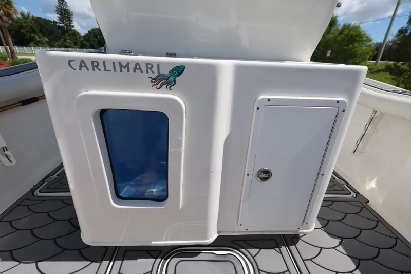 Slide: The Image of 2021 Tidewater 256 CC Adventure boat interior with storage compartment and decorative flooring. - 20