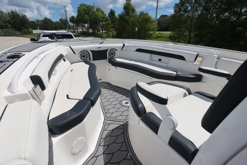 Slide: The Image of 2021 Tidewater 256 CC Adventure boat interior with cushioned seating and modern design. - 9