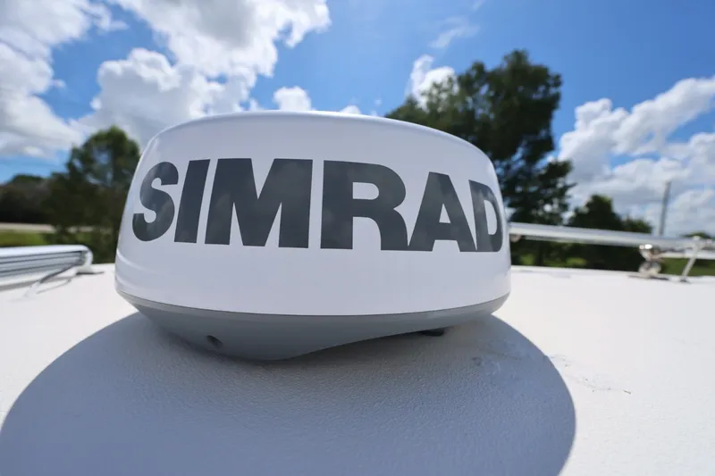 Slide: The Image of Simrad radar on 2021 Tidewater 256 CC Adventure boat under blue sky. - 26