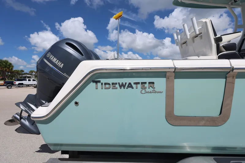 Slide: The Image of 2021 Tidewater 256 CC Adventure boat with Yamaha engine under clear sky. - 6