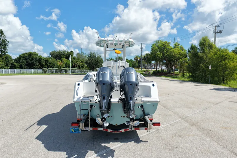 Slide: The Image of 2021 Tidewater 256 CC Adventure boat with dual outboard motors on a trailer. - 4
