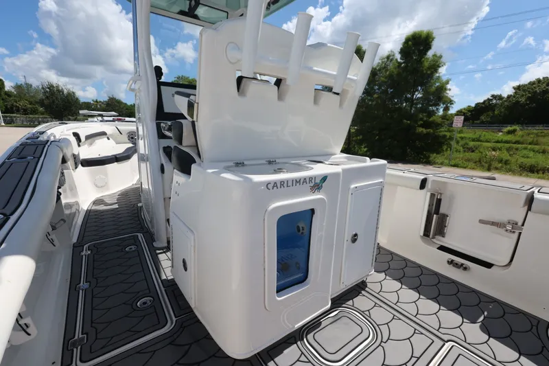 Slide: The Image of 2021 Tidewater 256 CC Adventure boat interior with rod holders and storage compartments. - 19