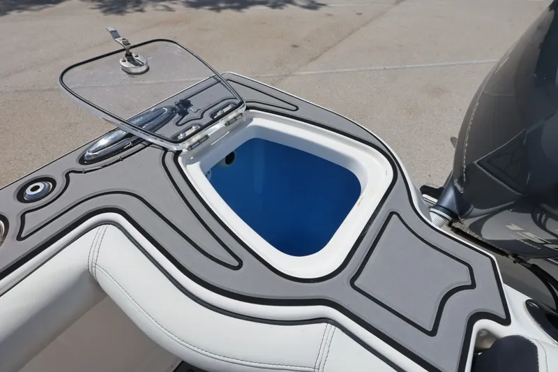 Slide: The Image of 2021 Tidewater 256 CC Adventure boat with open storage compartment. - 21