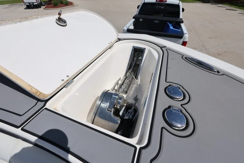 Slide: The Image of Open anchor compartment on 2021 Tidewater 256 CC Adventure boat, with visible anchor mechanism. - 23