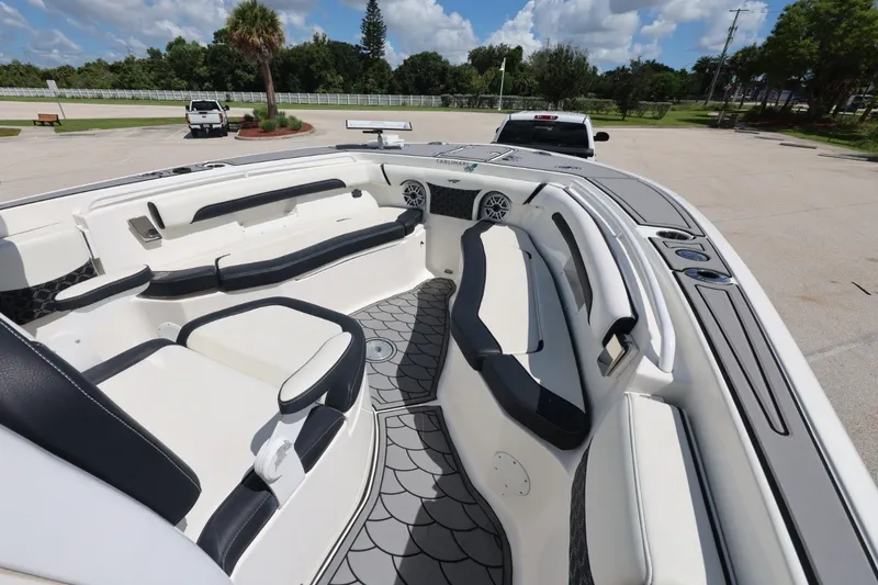 Slide: The Image of The image shows the spacious cockpit of a 2021 Tidewater 256 CC Adventure boat with sleek seating. - 11