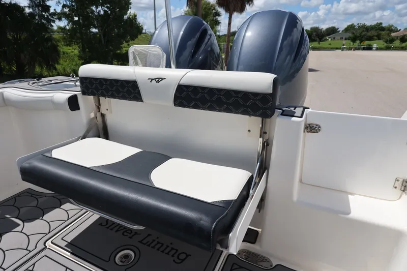 Slide: The Image of 2021 Tidewater 256 CC Adventure boat with dual engines and cushioned seating. - 15