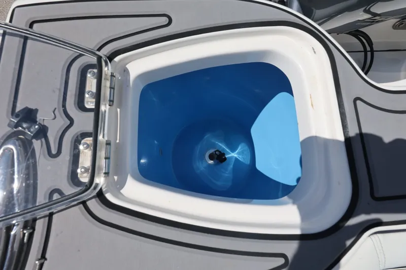 Slide: The Image of Open hatch on 2021 Tidewater 256 CC Adventure boat, revealing blue interior compartment. - 22