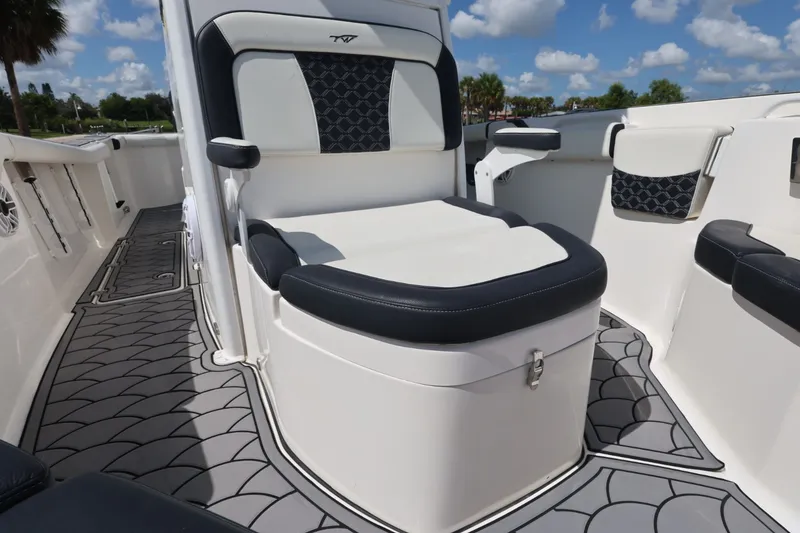 Slide: The Image of 2021 Tidewater 256 CC Adventure boat interior with cushioned seating and stylish flooring. - 12