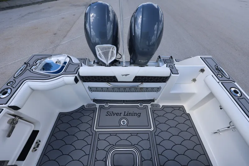 Slide: The Image of 2021 Tidewater 256 CC Adventure boat deck with dual engines and custom flooring. - 16